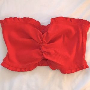 Strapless red cropped top.